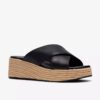 Mules Tessiah pour femme, compensées en cuir noir Mules Tessiah pour femme, compensées en cuir noir